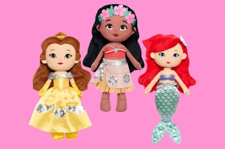 three disney princess plush dolls on a pink background 