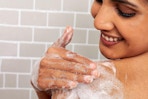 Aveeno Body Wash woman lathers her shoulder and smiles