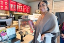 a woman holding a receipt and a cup
