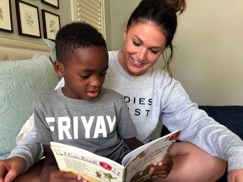 a woman reading a book with her child