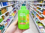hand holding garnier fructis leave in conditioner walgreens