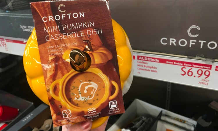 Hand holding up a pumpkin shaped dish in an Aldi store