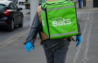 A person with an uber eats cooler backpack on their back.