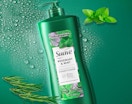 a green bottle of hair conditioners