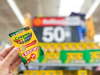 Crayola Crayons held in front of $0.50 rollback sign at Walmart
