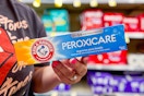 person holding a box of arm & hammer toothpaste