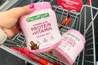 2 containers of natures bounty protein powder in a cart