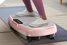 person standing pink vibration plate