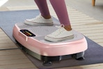 person standing pink vibration plate