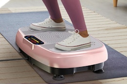 person standing pink vibration plate