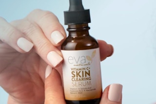 Person holding a vitamin c serum in their hands.