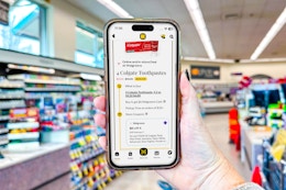 hand holding smartphone in a store
