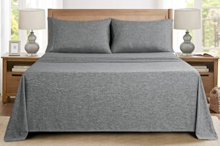 Lifestyle image of Mainstays 4-piece sheet set on bed in room setting 
