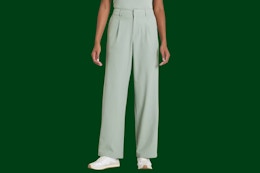 Stock image of woman wearing a pair of sage green trouser pants from the brand All in Motion from Target
