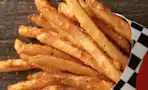 A close up of a large fry from Checkers on a table.