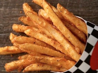 A close up of a large fry from Checkers on a table.