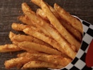 A close up of a large fry from Checkers on a table.
