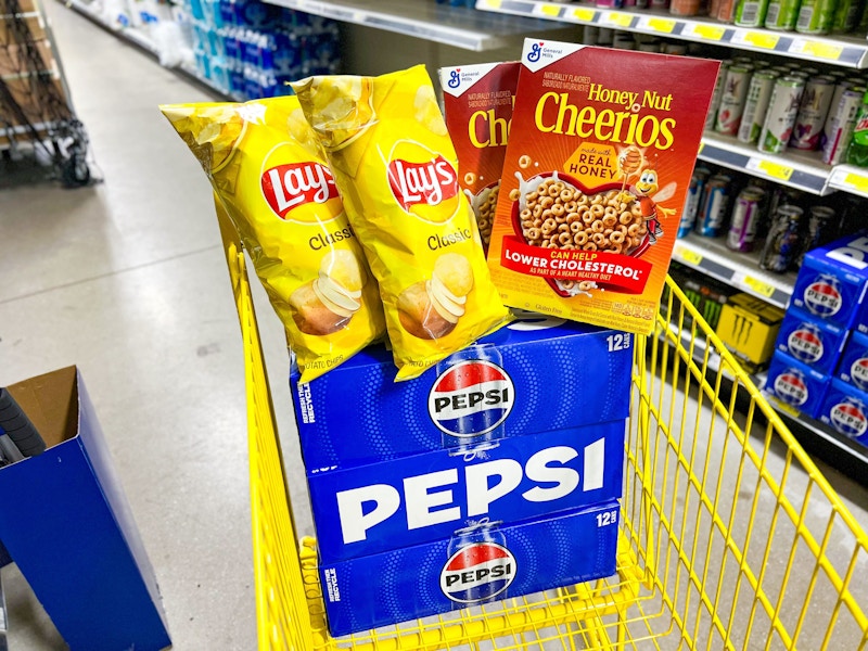 2 bags of lays, 2 boxes of honey nut cheerios, and 3 cases of pepsi in a cart