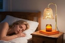 a woman sleeping next to a candle warmer lamp