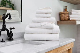 Lifestyle image of a Linens & Hutch towel set of 6 on bathroom counter