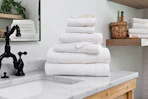 Lifestyle image of a Linens & Hutch towel set of 6 on bathroom counter