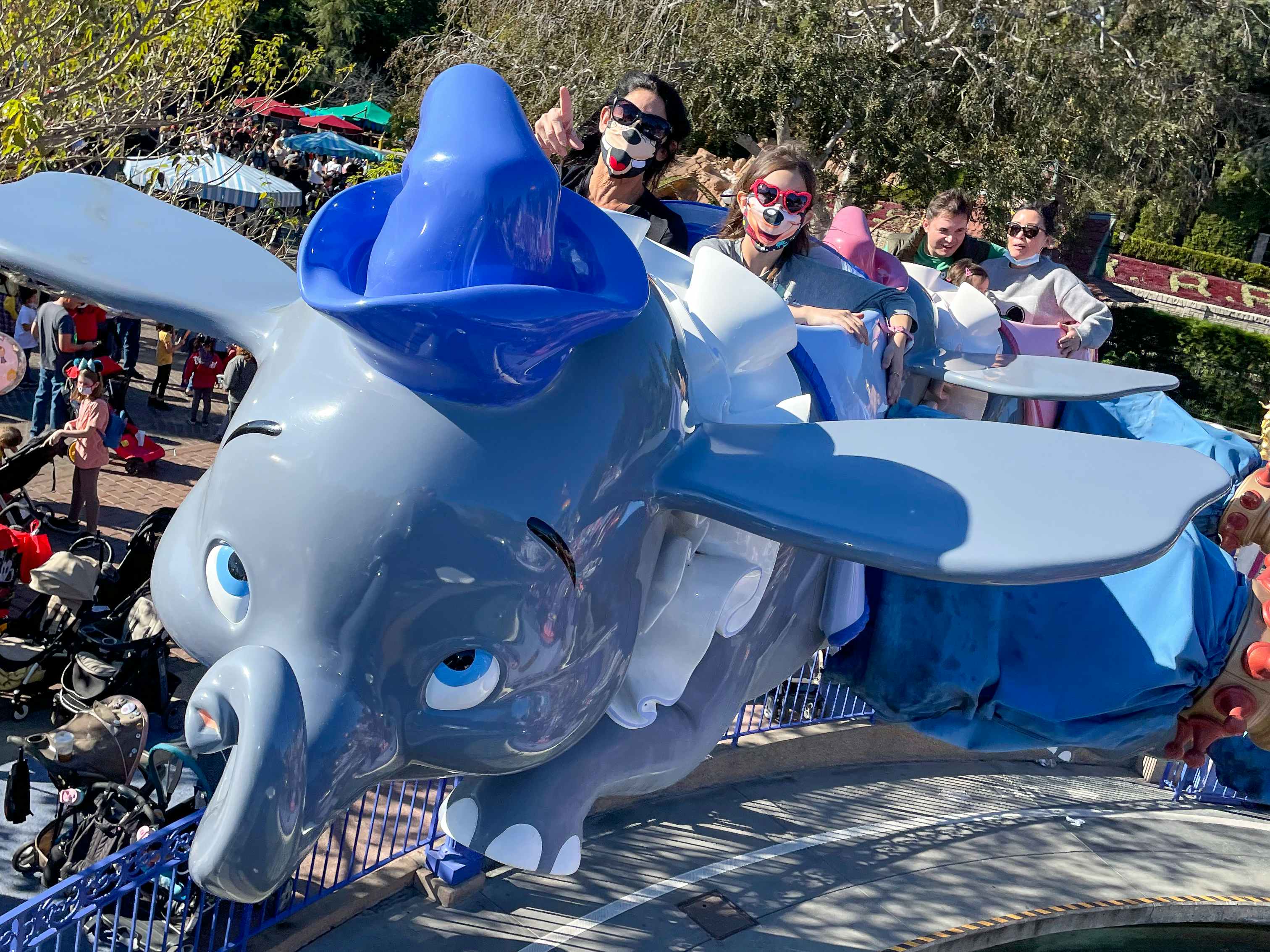 People riding on a Dumbo ride at Disneyland in California