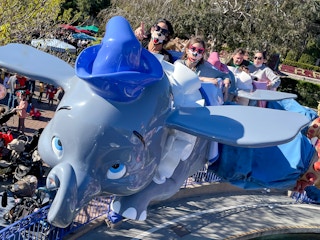 People riding on a Dumbo ride at Disneyland in California