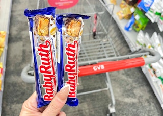 two baby ruth candy bars held in front of cvs shopping cart