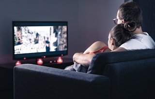 Couple streaming a free movie on TV.