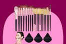 Twenty makeup brushes with reddish purple handles of varying size are lined up below three triangular purple powder puffs.
