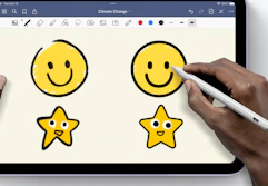 a person using a stylus pen on an iPad