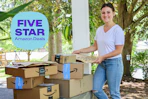 a woman carrying amazon boxes