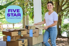 a woman carrying amazon boxes