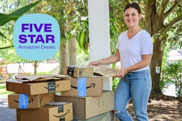 a woman carrying amazon boxes