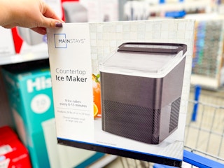 hand holding mainstays countertop ice maker on walmart cart