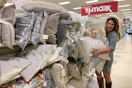 A woman holding a bunch of pillows.