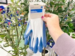 hand holding a pair of gardening gloves at target