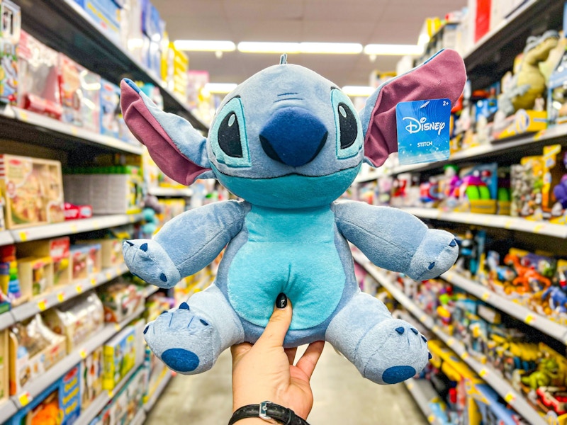 hand holding disney-stitch-plush in walmart toy aisle