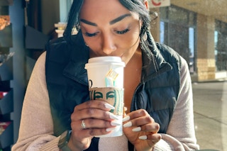 a woman drinking a starbucks medicine ball 