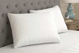 Lifestyle image of the Sealy Essentials All Positions Bed Pillow Set in bedroom setting