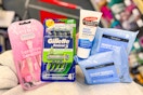 person holding neutrogena makeup wipes, palmers foot cream, and gillette and venus razor packs