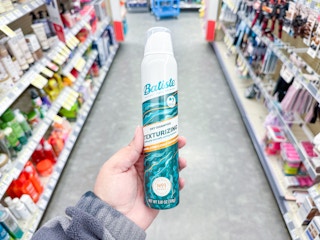 hand holding batiste dry shampoo in walgreens
