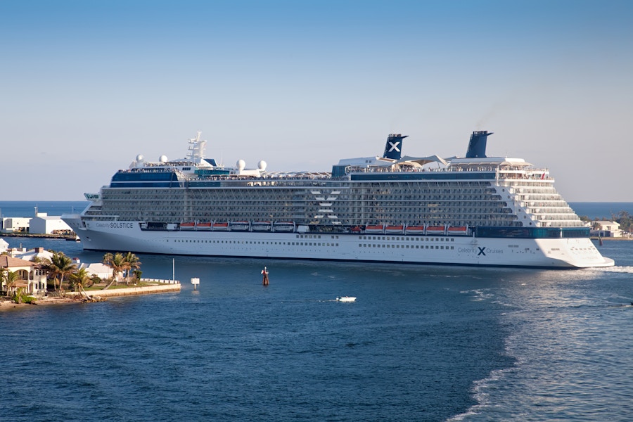 The Celebrity Solstice cruise ship departing from a pier.