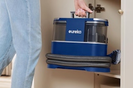 person placing carpet cleaner in a cabinet