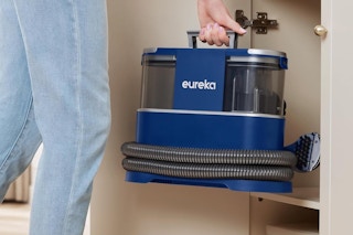 person placing carpet cleaner in a cabinet