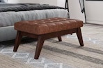 Lifestyle image of the Distressed Saddle Brown of the Simpli Home Ottoman in home setting