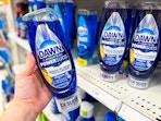 hand holding a bottle of dawn powersuds in front a target shelf