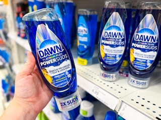 hand holding a bottle of dawn powersuds in front a target shelf