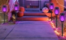 purple Halloween torch lights in front of a house 