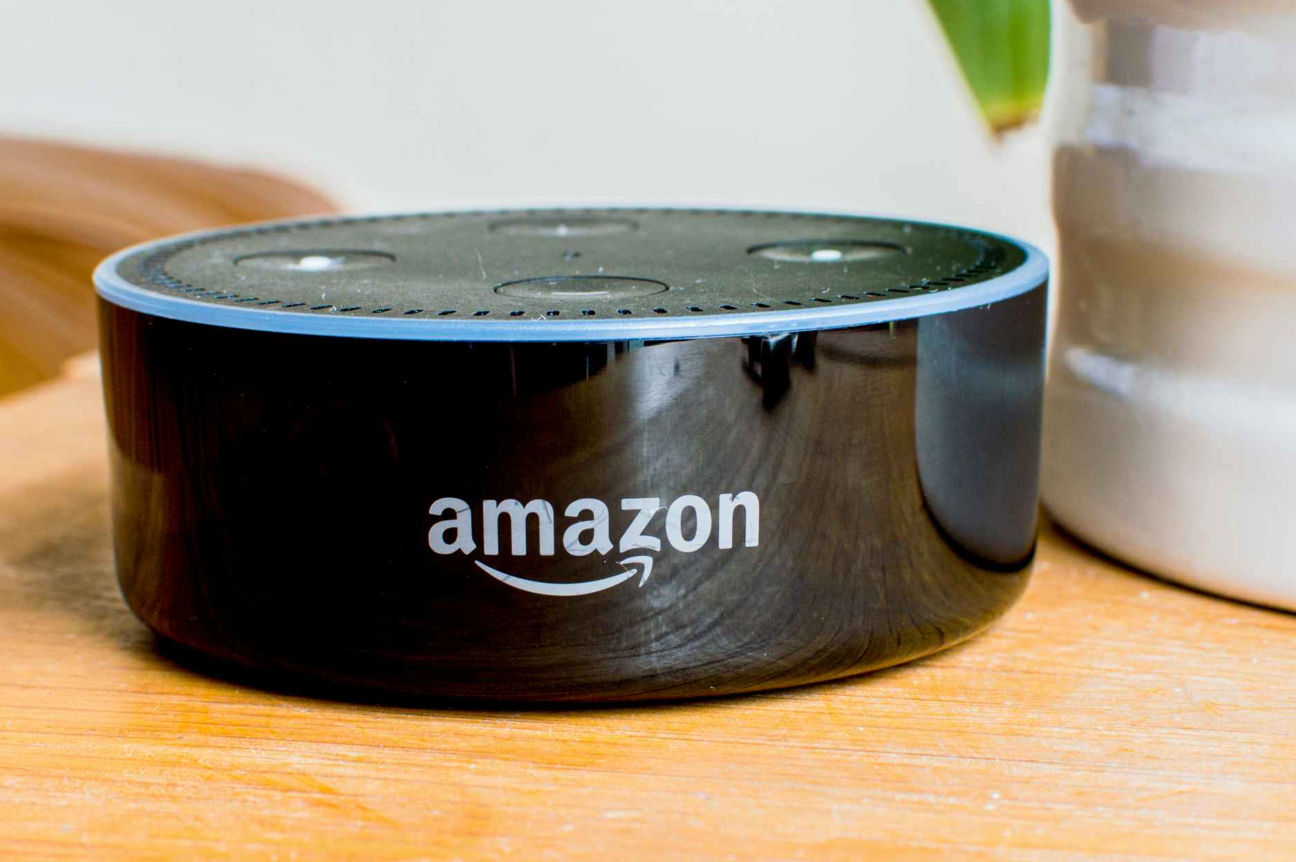 Amazon echo dot speaker sitting on a table